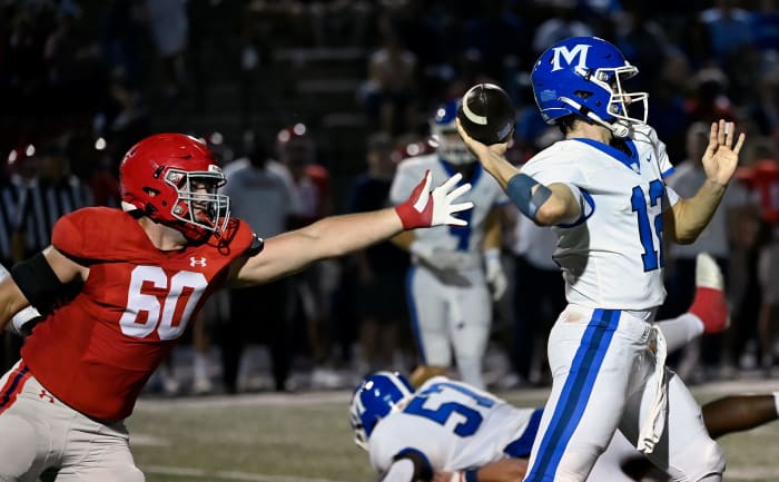 Brentwood Academy s Hank Weber (60) reaches in trying to stop McCallie quarterback Jeremy St-Hilaire (12) from passing the ball during an high school football game Friday, Sept. 15, 2023, in Brentwood, Tenn.